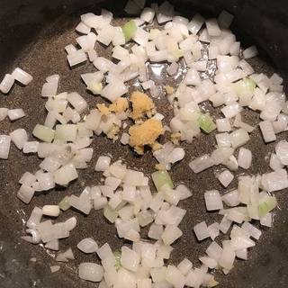Meanwhile, pour in olive oil in a skillet over medium heat then add chopped onion and saute about 3 to 4 minutes until the onions are tender, then add the minced garlic and saute just for 1 minute more.