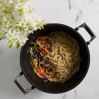 Now add the chicken and the noodles to the vegetables and mix them well. Add the rest of the sauce to your pan and fry them on high heat.